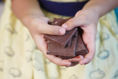 A Person Holding Chocolate Bars 