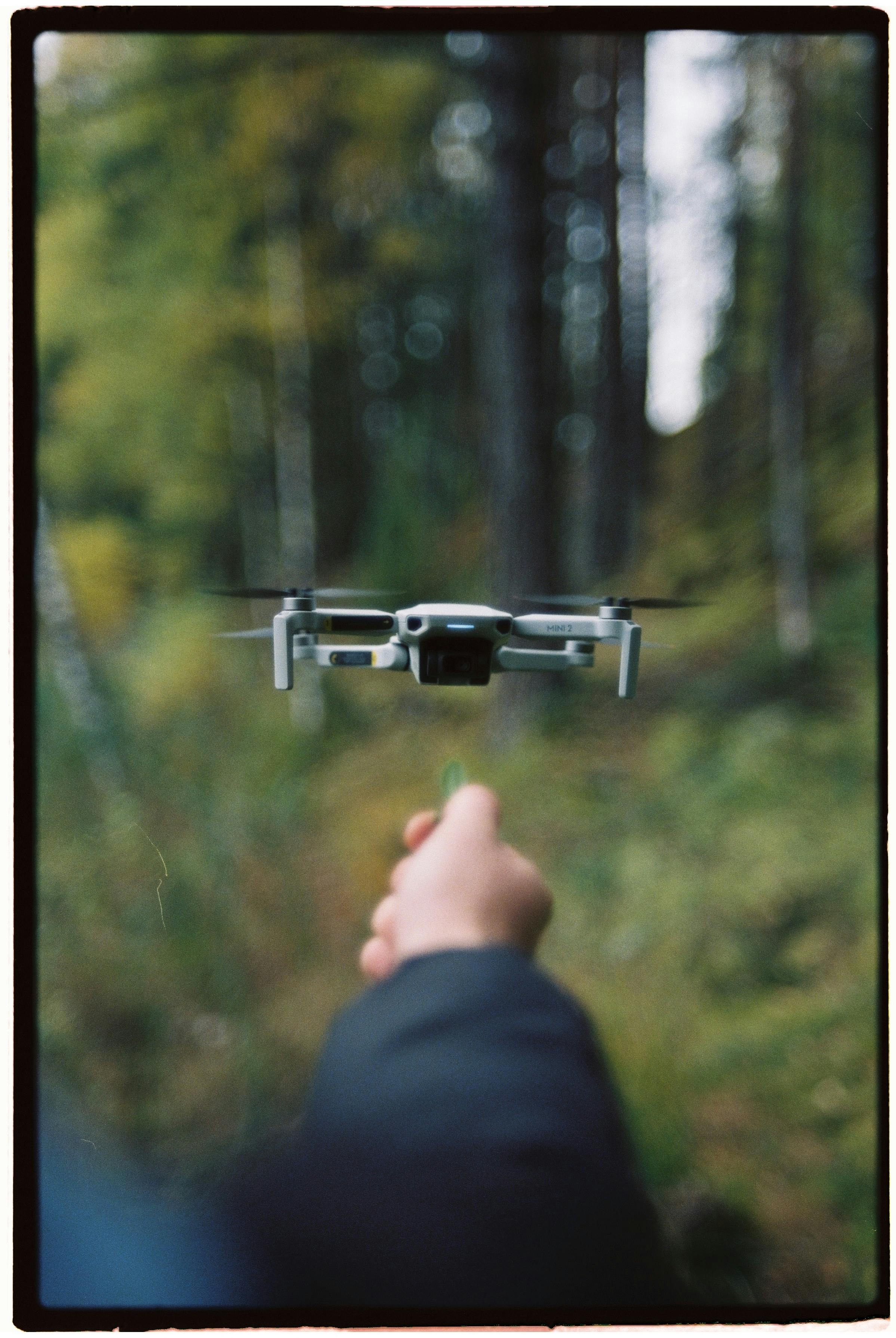 person holding black and gray drone