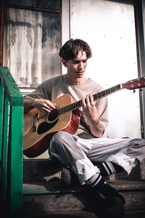 A Man Playing an Acoustic Guitar