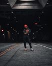 Teenage Girl in Black Outfit and Red Cap Standing on Road 