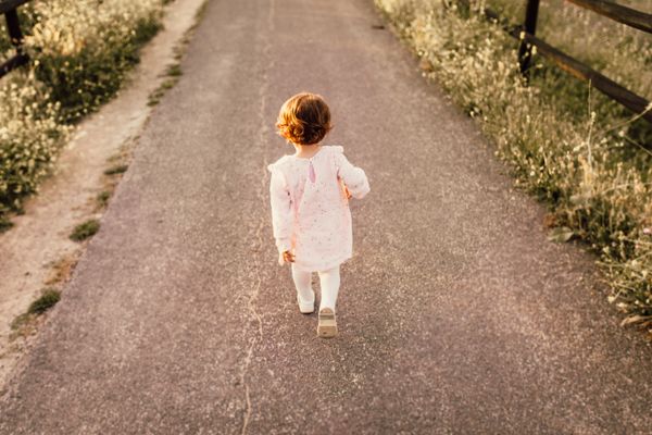 Person walking through a wildflower meadow, photo by Juan Pablo Serrano on Pexels