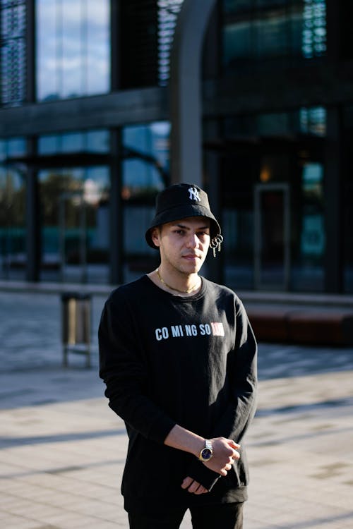 Man in Black Sweatshirt Wearing a Bucket Hat