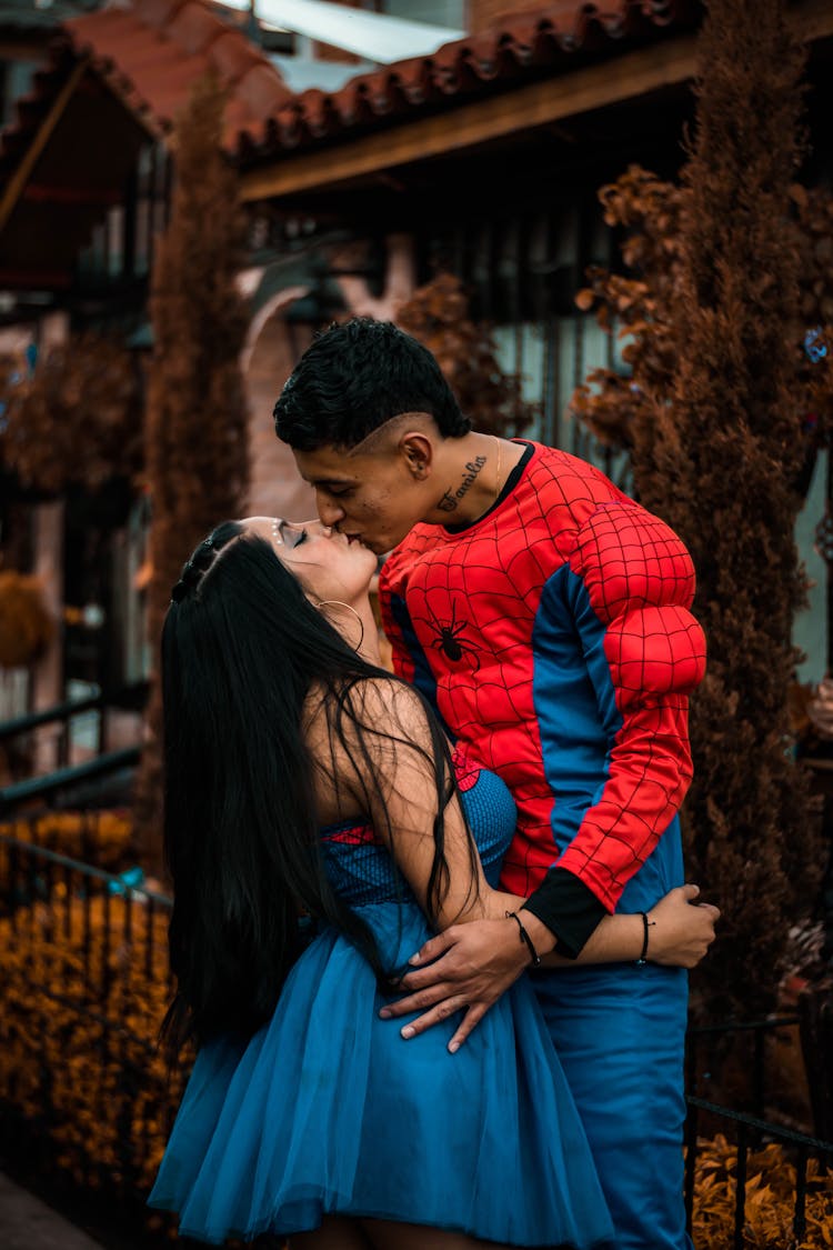 Man In Spiderman Costume Kissing Woman