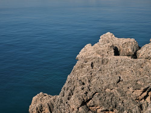 An Aerial Photography of a Rock Formation Near the Body of Water