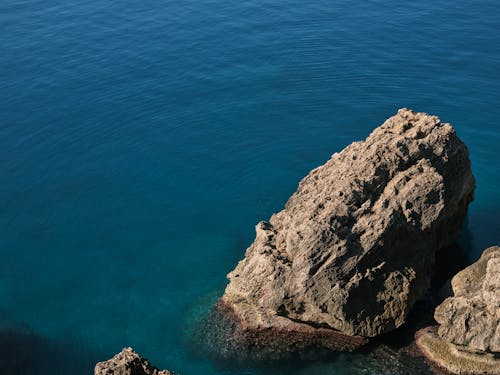 An Aerial Photography of a Rock Formation Near the Body of Water