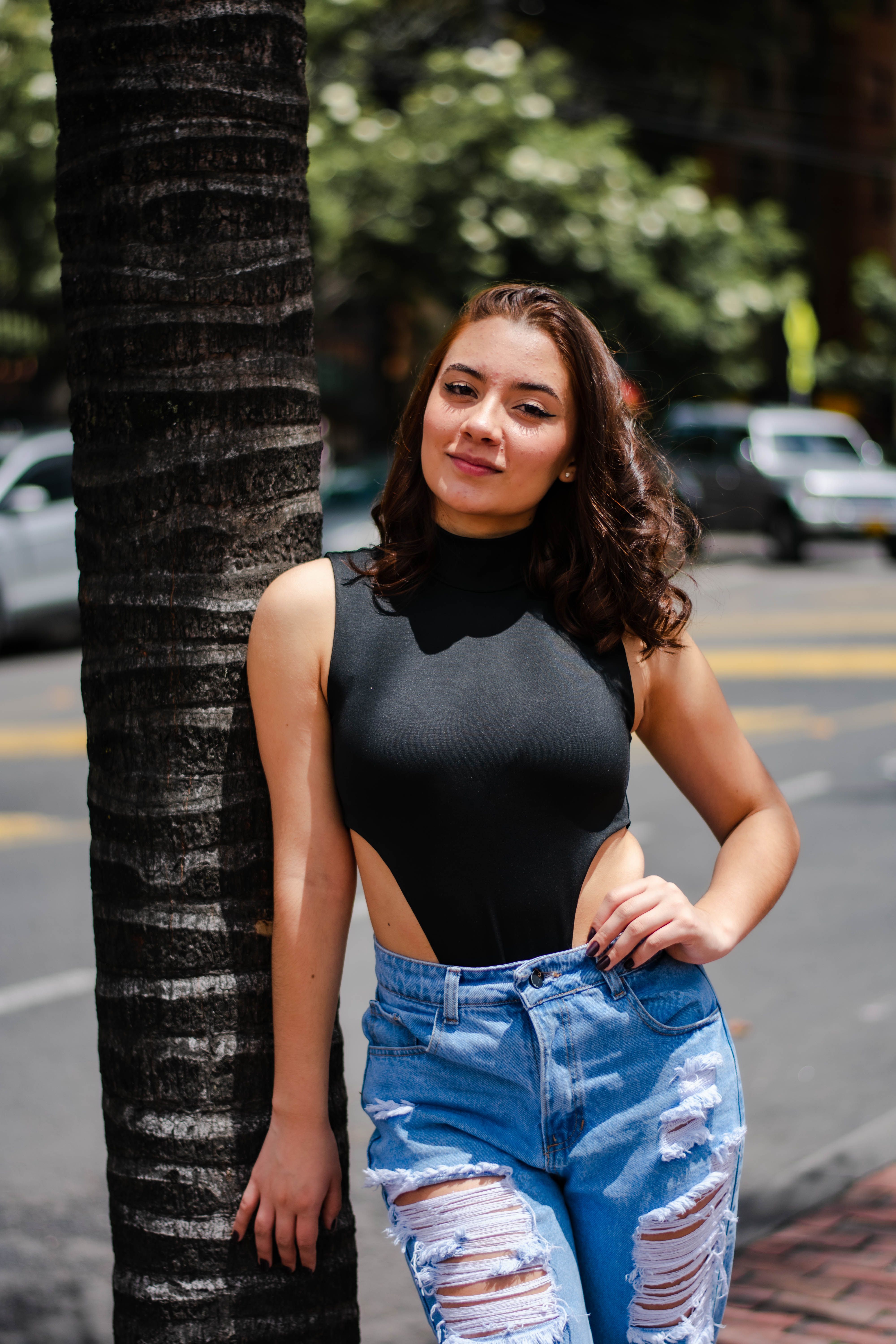 Woman in a Black Top Posing with Her Hand on Her Waist · Free Stock Photo