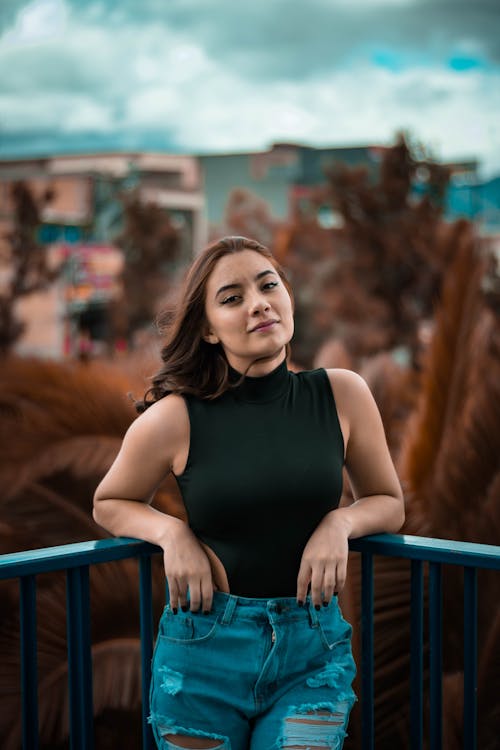 Brunette Woman Leaning on Railing