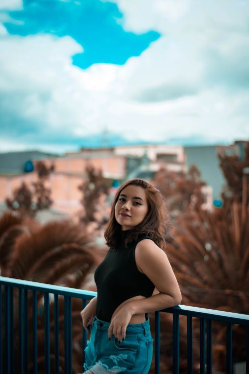 Leaning Back Against Railing Woman Leaning against Railing · Free Stock Photo
