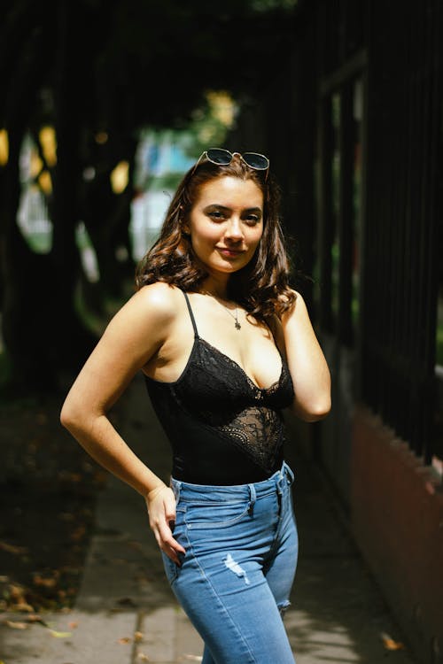 Woman in a Black Top Posing with Her Hand on Her Waist