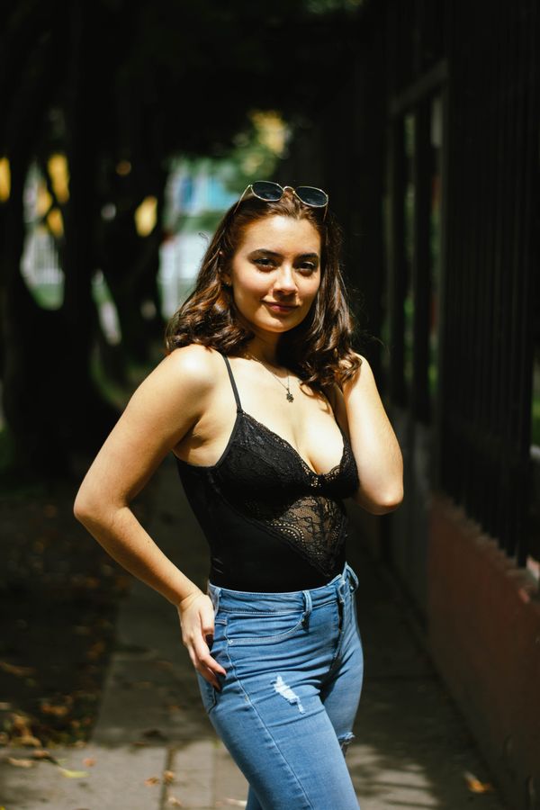 Woman in flare jeans with a black lace bodysuit