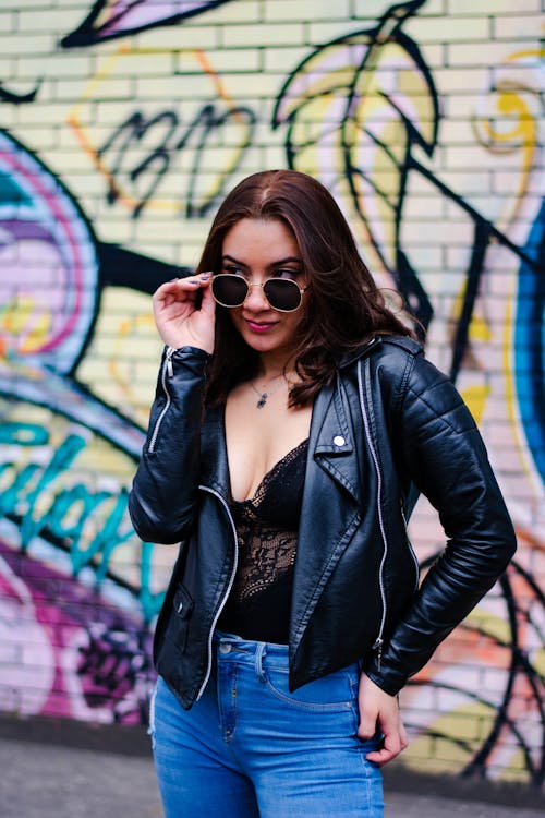 Woman in Black Leather Jacket Wearing Sunglasses