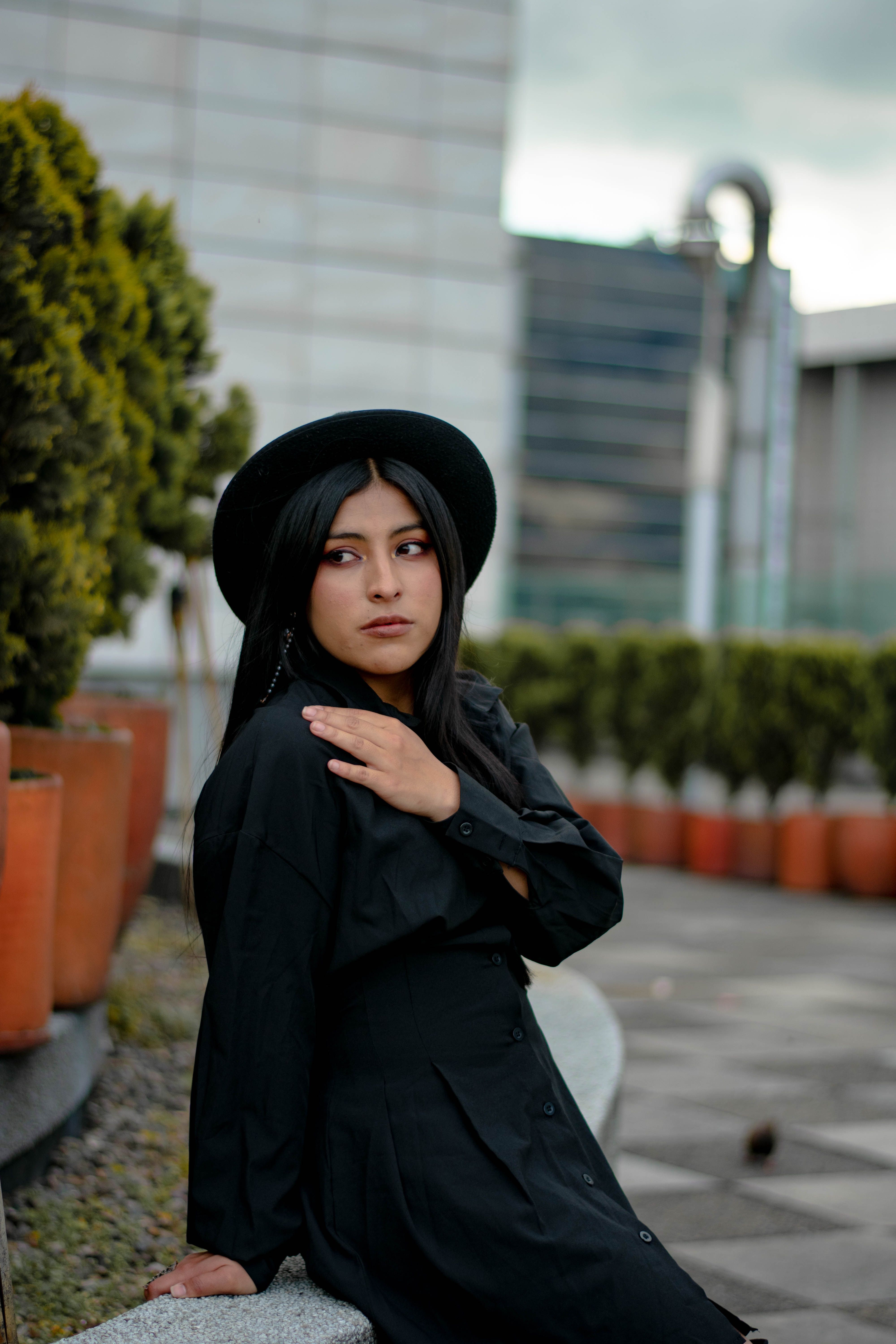 A Fashionable Woman Wearing a Black Hat and Long Sleeves · Free Stock Photo