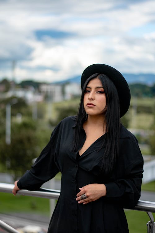 Young Woman in Black Clothing and Black Hat