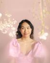 Smiling Young Woman in Pink Puffy Dress and Pink Background