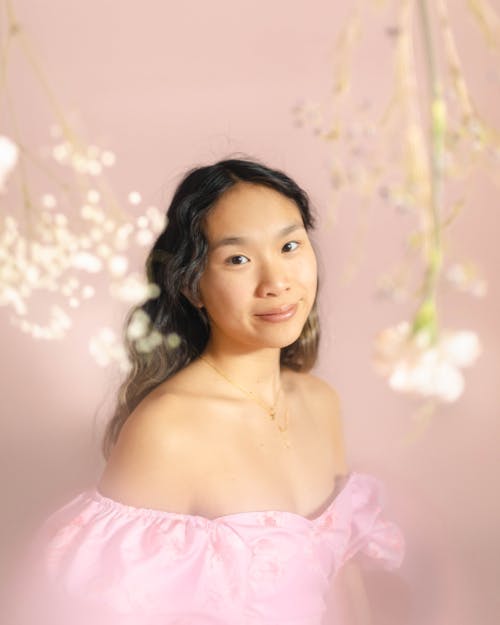 Charming Woman with Wavy Long Black Hair in Pink Dress