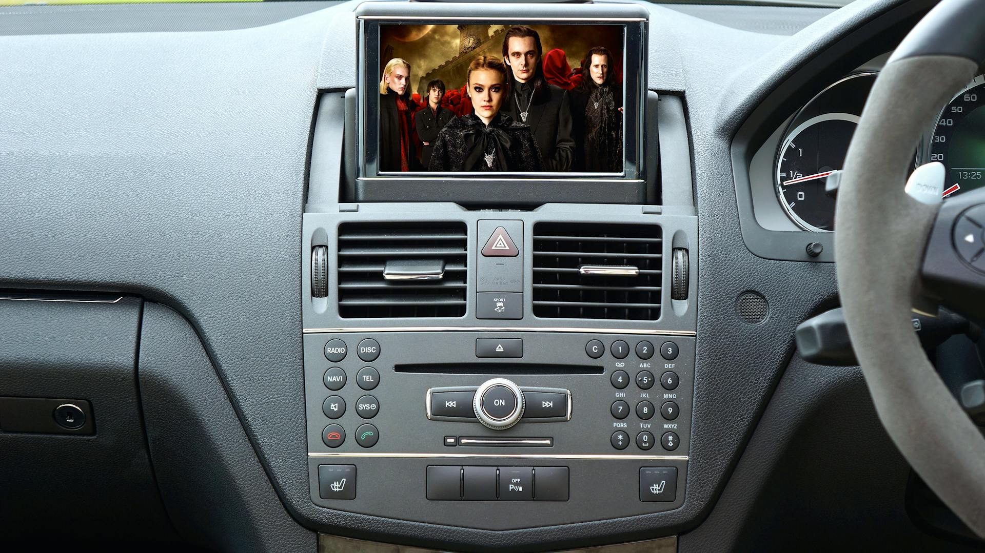 Modern car interior showcasing luxury dashboard and screen with movie image.