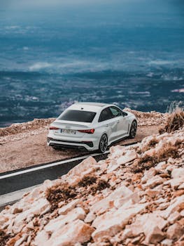 White Audi luxury car parked on Mont Ventoux, showcasing a scenic mountain road in Provence, France.