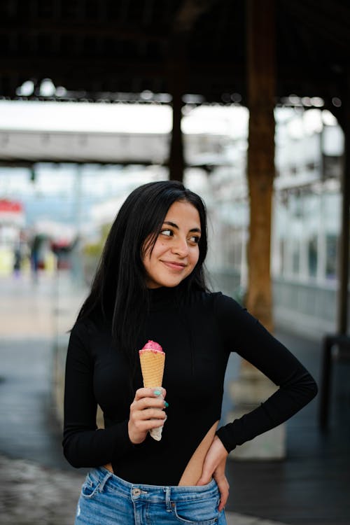 Woman in Black Long Sleeve Shirt Holding Ice Cream Cone