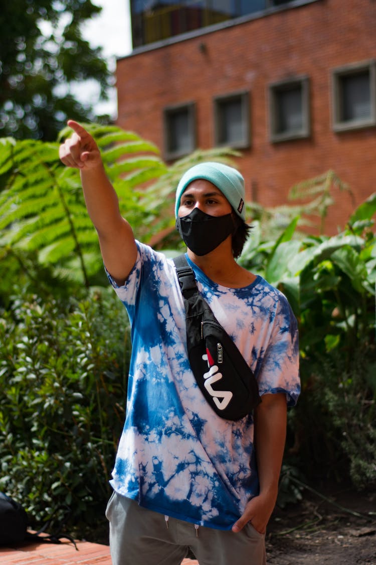 Teenager In Face Mask Pointing On Street