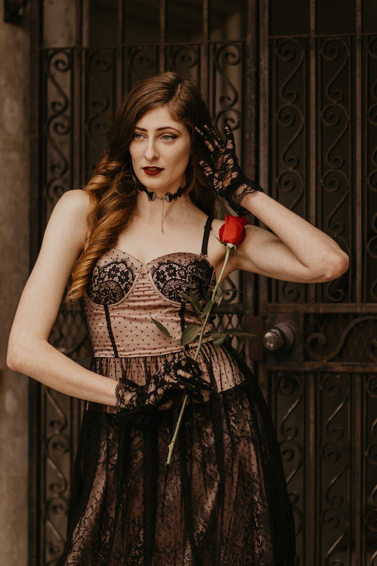 Redhead Woman With Red Rose Touching Hair