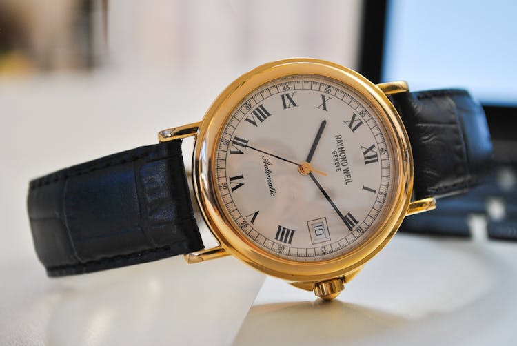 Round Gold-colored Analog Watch With Black Leather Strap At 10:10