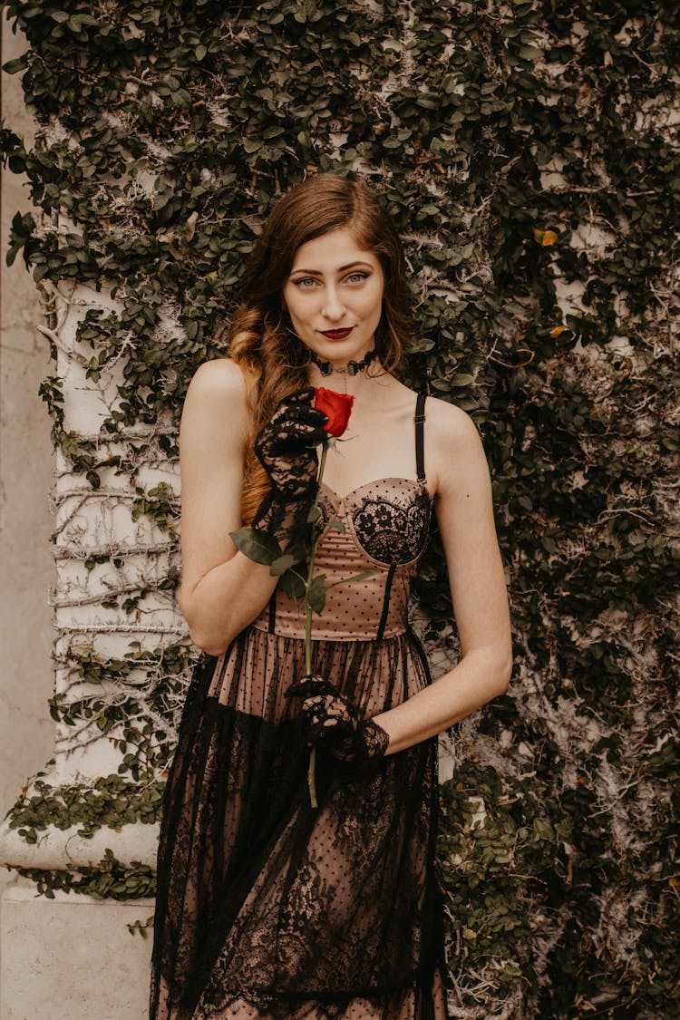 Redhead Woman In Vintage Dress Holding Red Rose