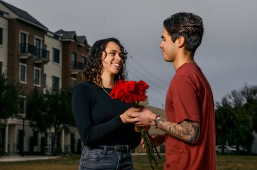 Man Presenting Woman Flowers Bouquet