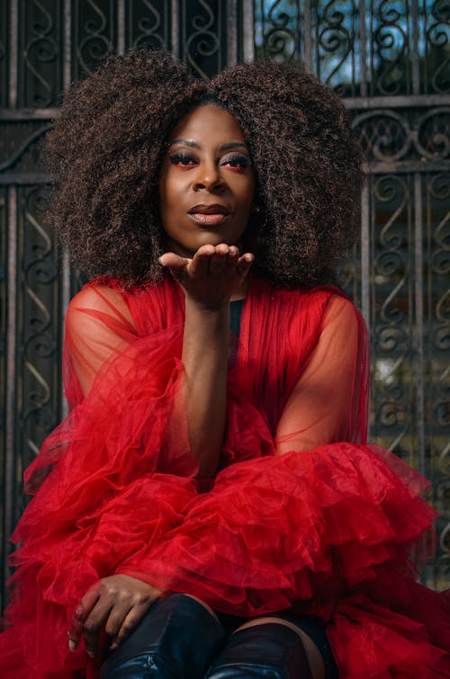 Woman in Red Dress Giving Flying Kiss 