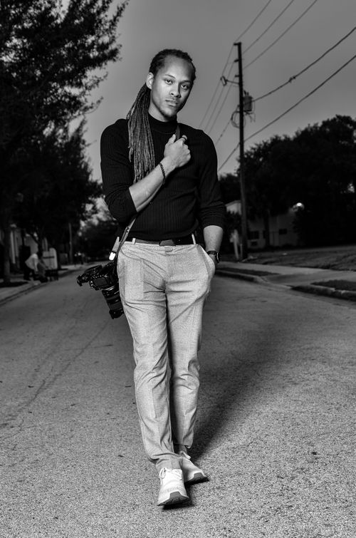 Free Black and white portrait of a photographer with a camera on an urban street. Stock Photo