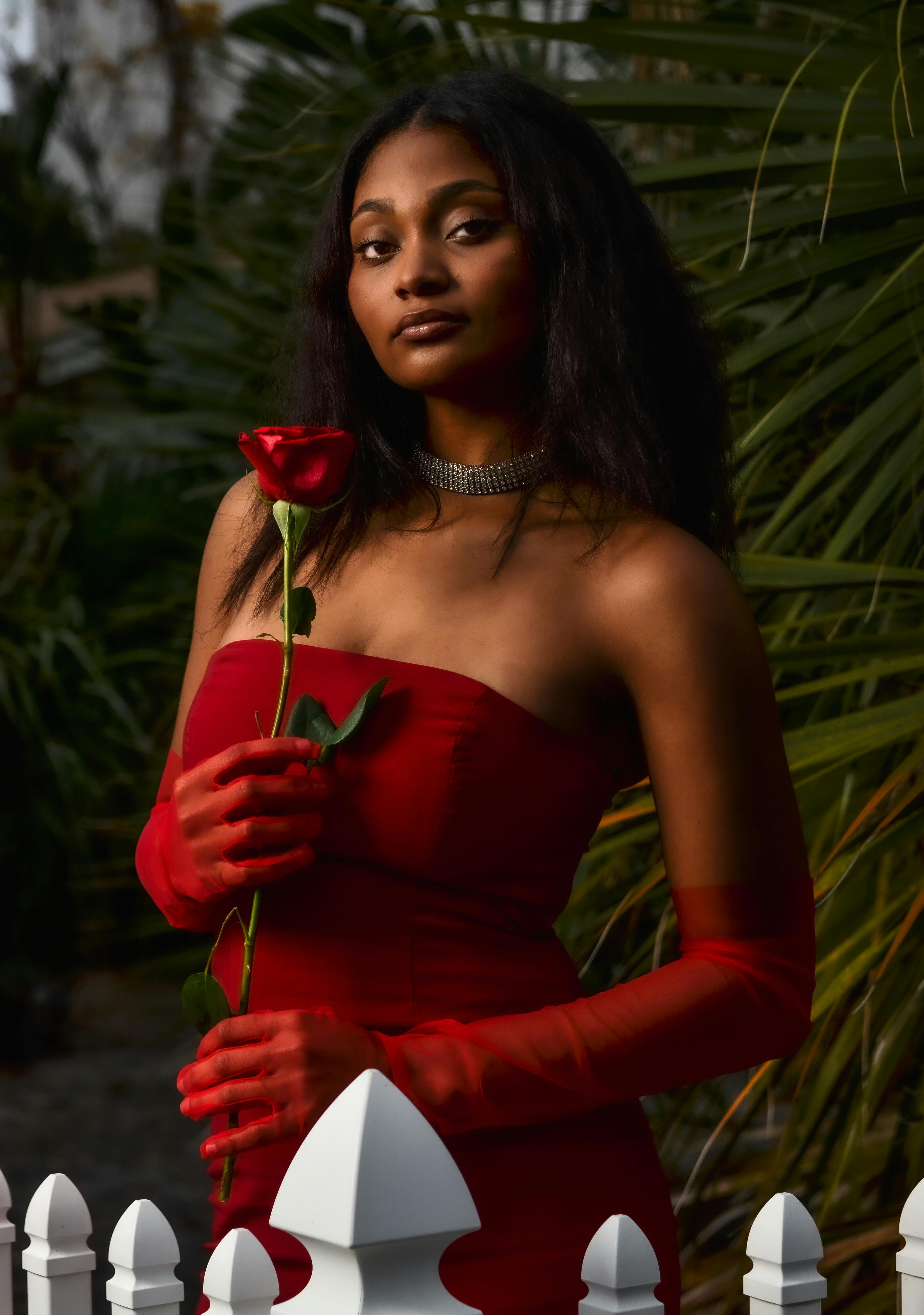 Young Woman Holding a Red Rose · Free Stock Photo