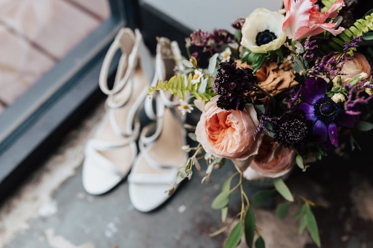 Bouquet Of Flowers Near White Heels 