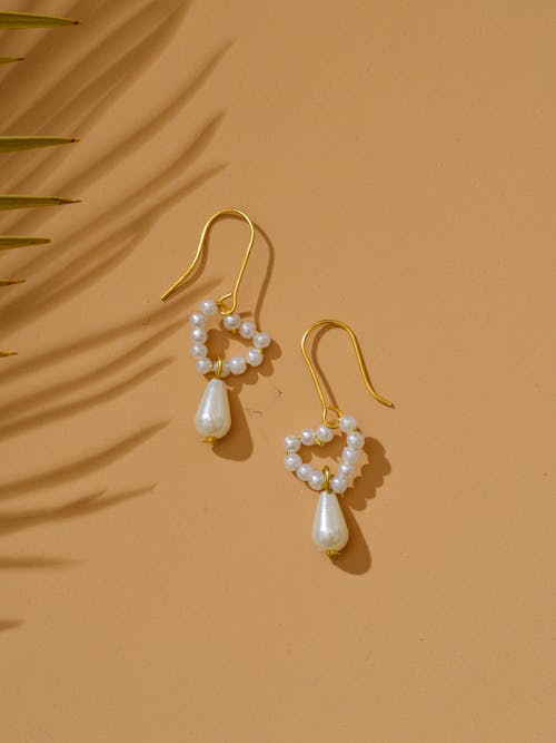 A Pearl Earrings on a Yellow Surface