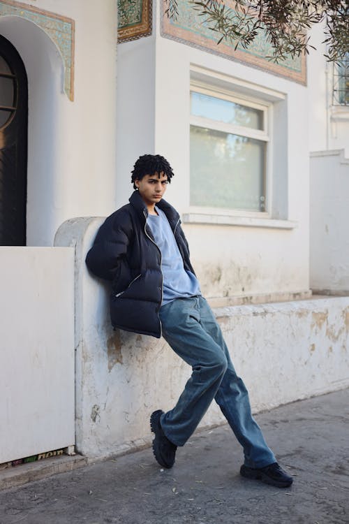 Young Man Leaning Against Fence