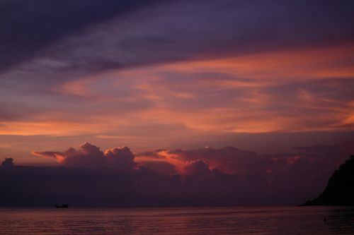 Free Dramatic twilight sky over the ocean with vibrant clouds and hues. Stock Photo