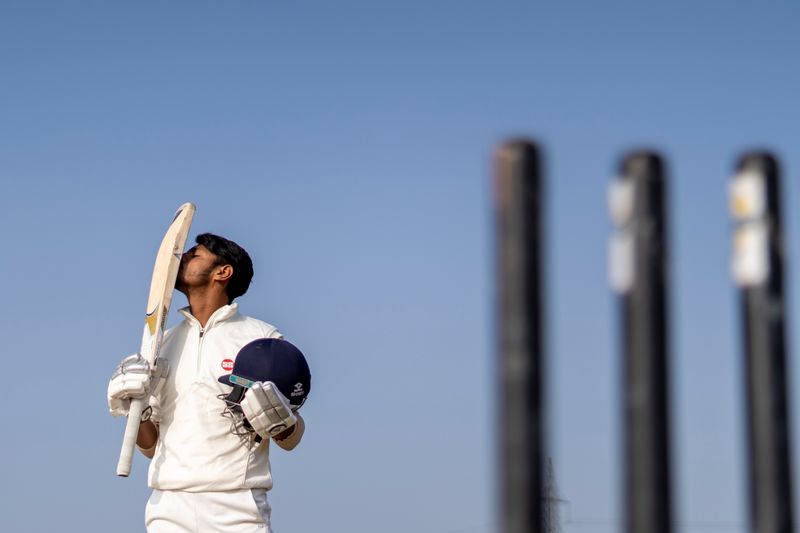 Cricket player celebrating in team uniform