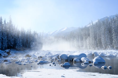 Free Snow Covered Rocks on a River Stock Photo
