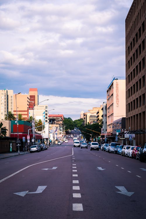 A Moving Cars on the Road Between Buildings