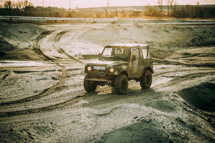 A Black Wrangler Jeep On A Muddy Terrain