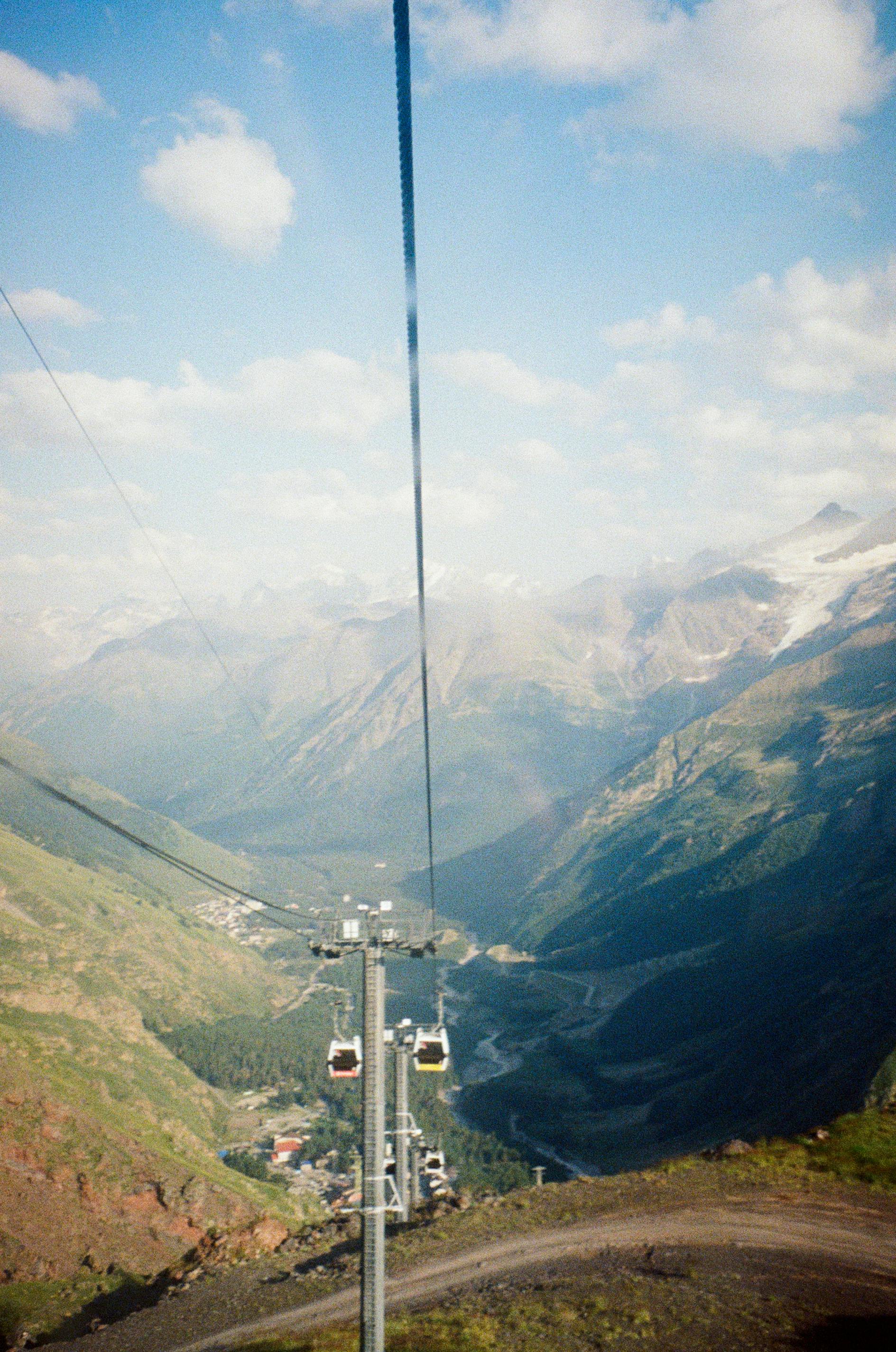 Prescription Goggle Inserts - Scenic view from a mountain cable car overlooking expansive valleys and peaks.