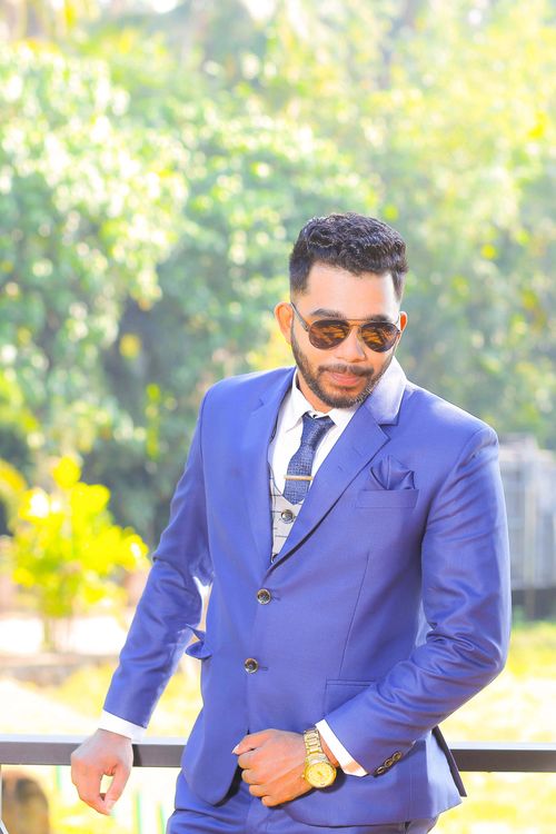 Free Confident businessman in blue suit with sunglasses outdoors in Sri Lanka. Stock Photo
