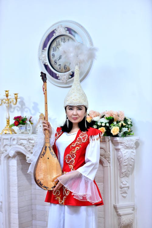 Woman in Traditional Clothing and with Instrument
