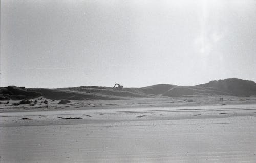 Free Grayscale Photo of the Backhoe in the Sand Dunes Stock Photo