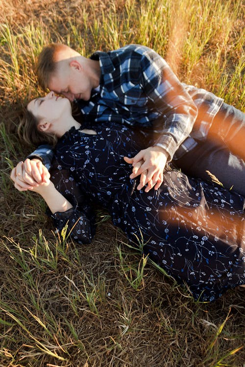 A Couple Lying Down on the Grass Together