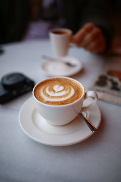 Cup of Coffee with Latte Art on Saucer