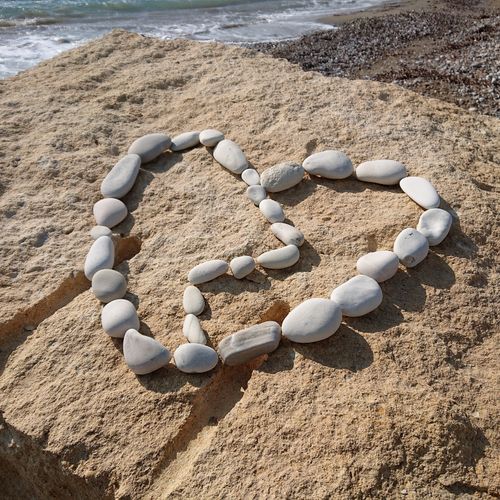 Free Broken hearted pebbles on beach Stock Photo