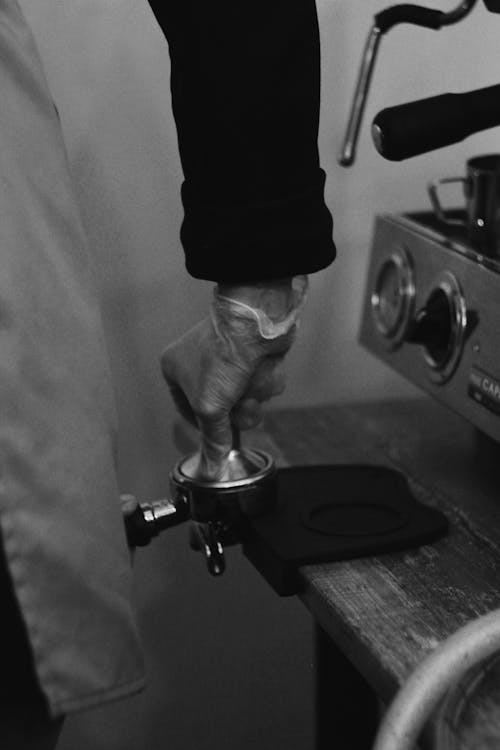 Black and White Photo of Making Coffee on a Coffee Machine