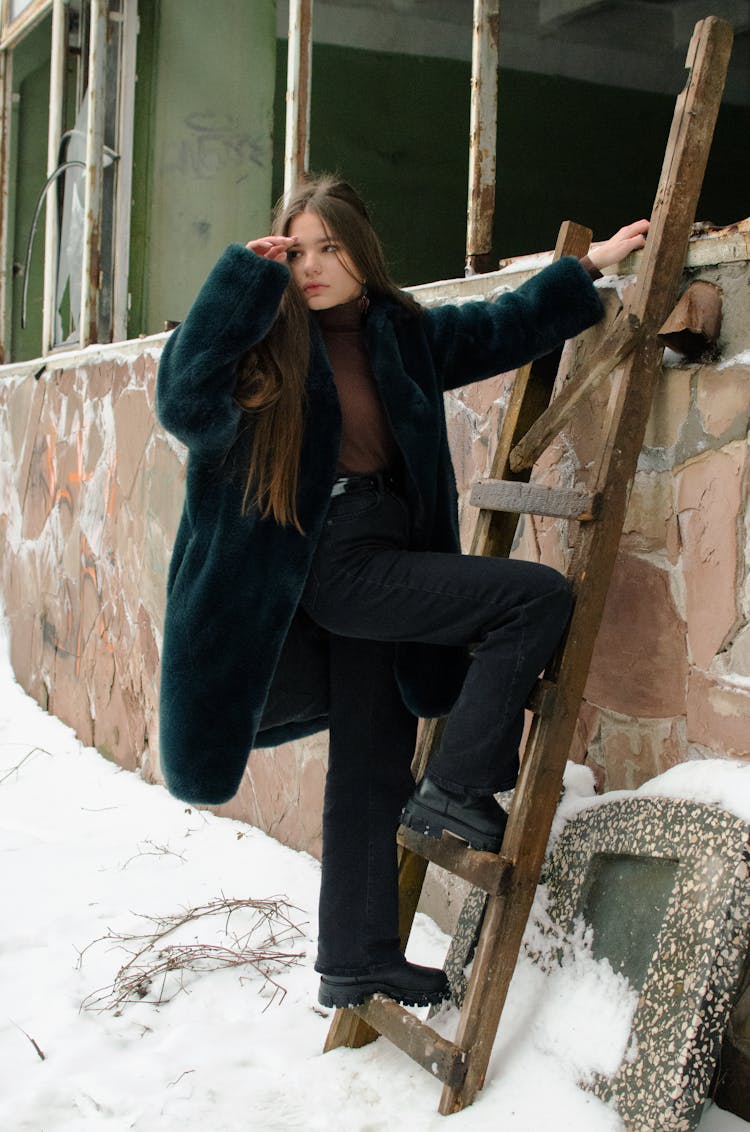 A Woman Wearing Black Jacket On The Ladder