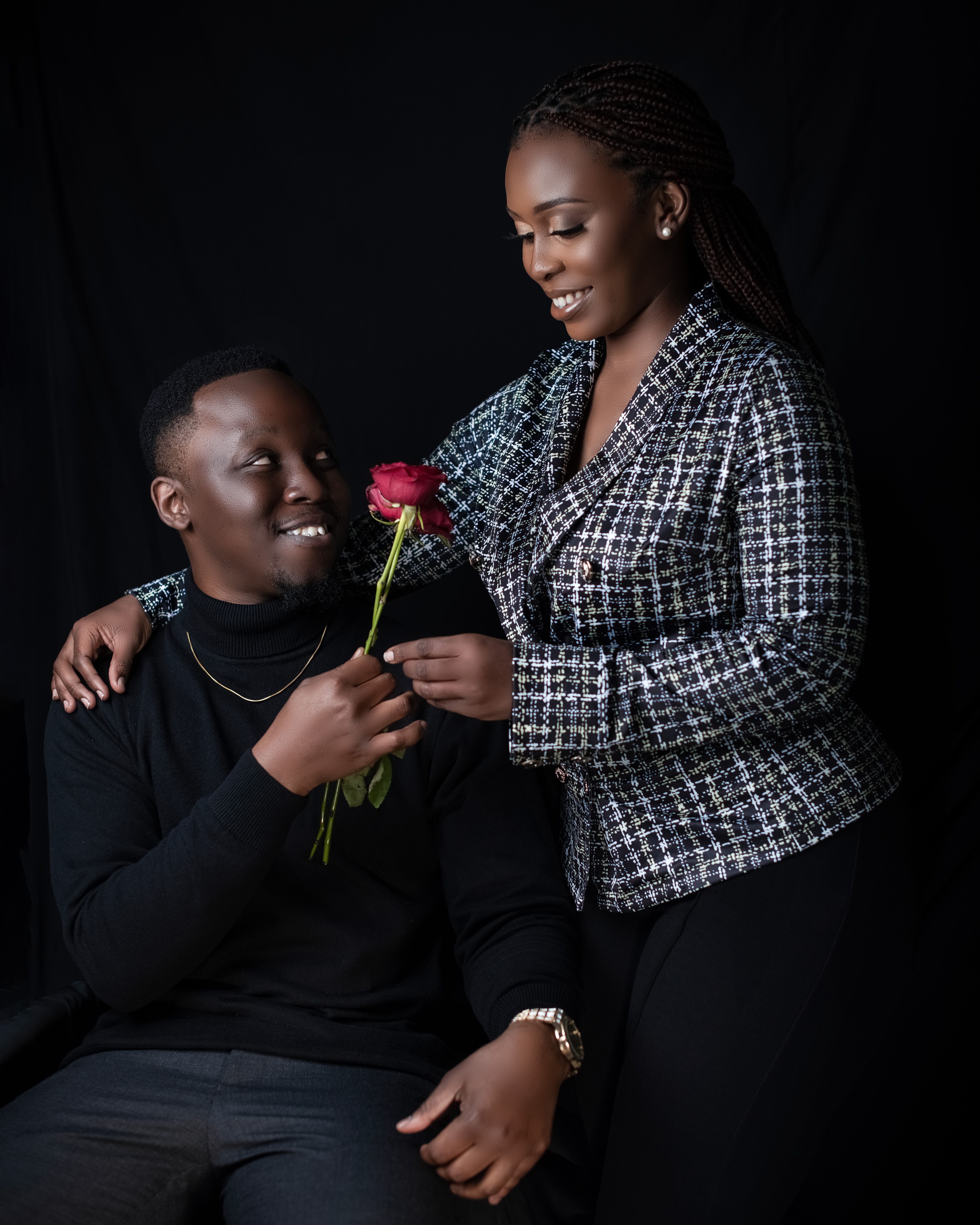 A loving couple shares a tender moment with a rose, symbolizing romance.
