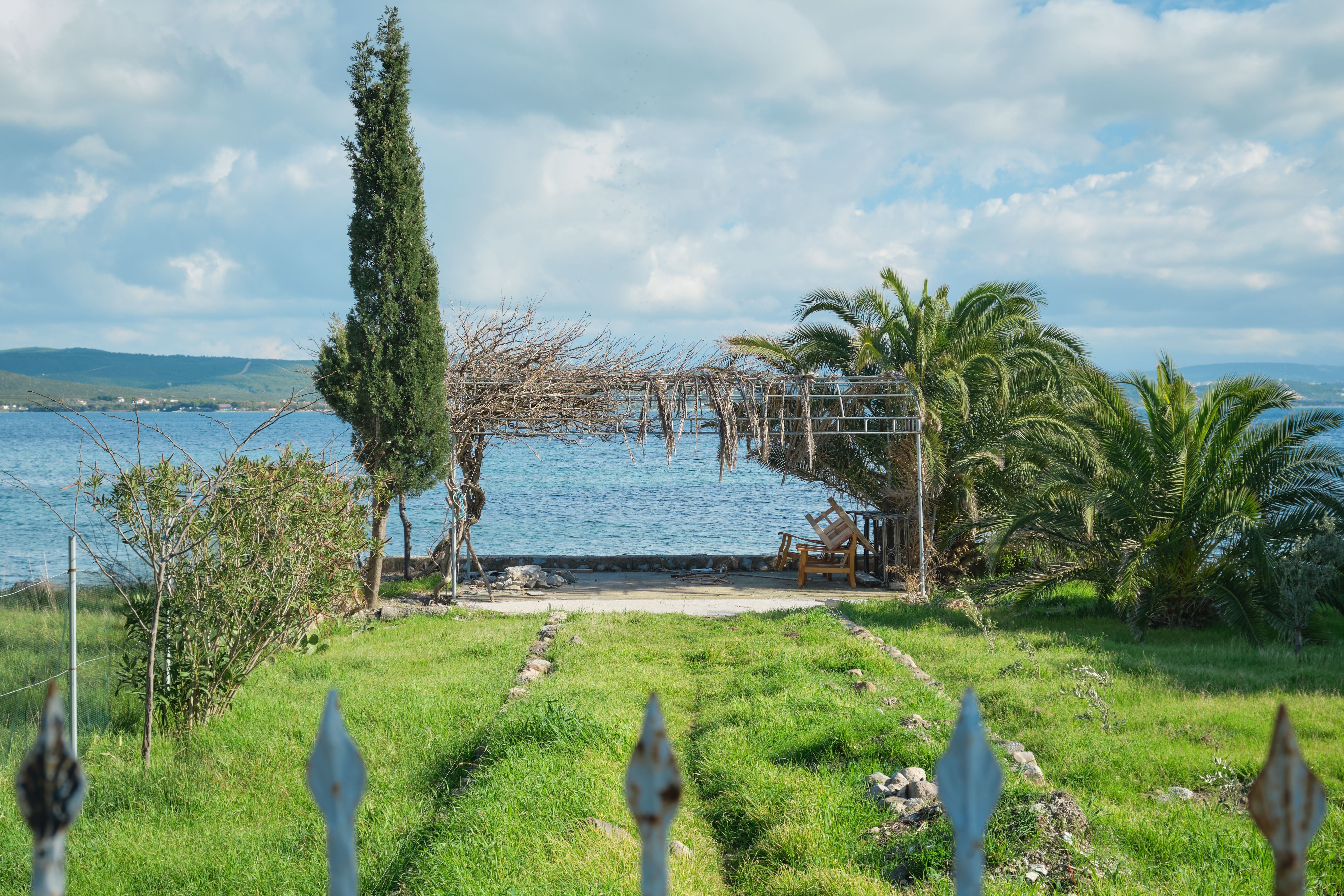 Lush coastal garden surrounding a private retreat suite at golden hour