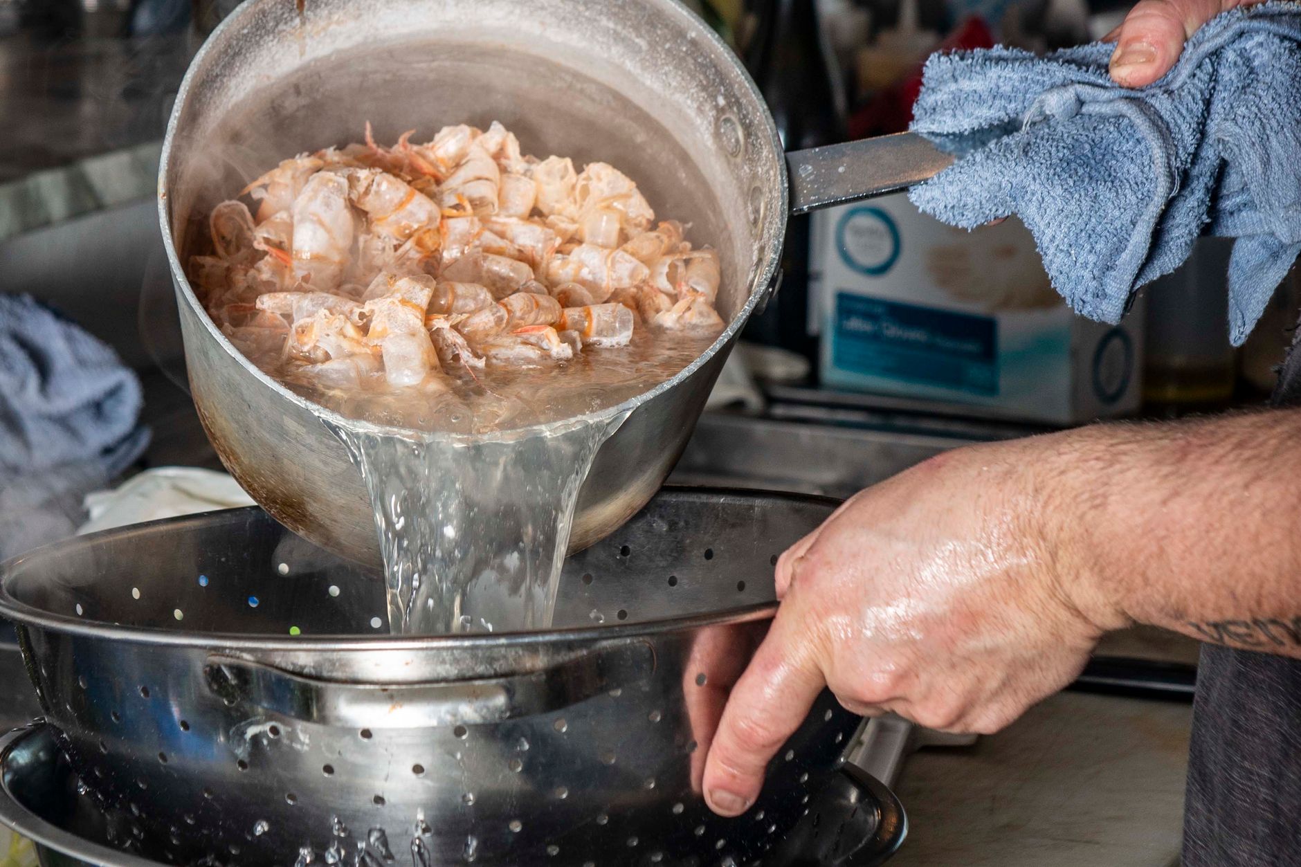 plumber unclogging commercial kitchen drain